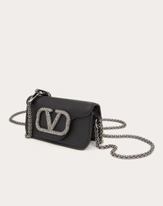 Valentino Garavani Locò micro bag in calfskin with chain and VLogo Signature element covered with Swarovski® crystals. Equipped with both a detachable sliding chain strap and a detachable handle, this accessory can be worn as a crossbody/shoulder bag or carried as a handbag. - Matching hardware - Magnetic closure - Removable leather handle - Shoulder strap with removable sliding chain - Nappa leather lining. Interior: one card slot Shoulder strap drop length: 55 cm / 21.6 in. - Handle drop lengt Luxury Chain Bags For Everyday, Luxury Wallet On Chain With Detachable Strap, Luxury Leather Shoulder Bag For Events, Luxury Evening Wallet On Chain With Chain Strap, High-end Evening Bag With Chain Strap, Luxury Chain Bag For Events, Luxury Shoulder Bag For Events, Luxury Leather Wallet On Chain For Parties, Silver Leather Wallet On Chain With Chain Strap