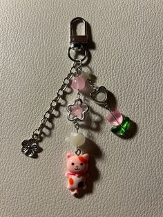 a keychain with a cat charm attached to it