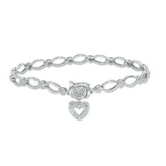 Dress her wrist with this charming bracelet for any special occasion. Crafted in sterling silver, this enchanting style features oval links alternating with heart-shaped stations adorned with diamond accents. At the clasp, a diamond-accented heart-shaped design and dangle heart charm complete this thoughtful look. Polished to a bright shine, this 7.25-inch bracelet secures with a box clasp. Jewelry Lookbook, Silver Charm Bracelet, Diamond Charm, Heart Earrings Studs, Diamond Bracelets, Sterling Silver Heart, Diamond Heart, Heart Charm Bracelet, Bracelet Designs