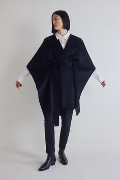 The defining feature of this poncho is its versatile belted design, allowing you to cinch the waist for a more tailored look or wear it open for a relaxed, flowy style. Embrace the freedom of movement and adaptability this piece provides, making it a versatile addition to your wardrobe. Oversized fit Lightweight wool fabric Long sleeves Boat neck Open Poncho Outfit, Black Poncho Outfit, Open Poncho, Poncho Outfit, Formal Tuxedo, Flowy Style, Freedom Of Movement, The Freedom, Wool Fabric