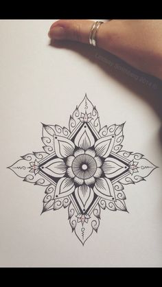 a drawing of a flower in black and white with an intricate design on the paper