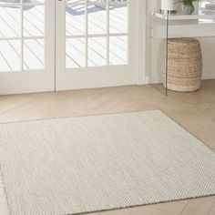 a white rug on the floor in front of a door