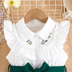 Introduce a whimsical element to your child's wardrobe with this charming White & Emerald Green Collared Embroidery Dress, perfect for summer festivities. Designed with a frilled neckline, fluttery sleeves, and a green skirt, this dress is sure to make a statement. The soft fabric ensures comfort and convenience, while the pull-over style allows for effortless dressing. Whether it's for school or play, this dress is an essential addition to any young fashionista's collection. Sizes range from 2T Summer Garden Party Dress With Ruffled Collar, Spring Dress With Ruffled Collar For Dress-up, White Butterfly Sleeve Dress For Garden Party, White Dress With Butterfly Sleeves For Garden Party, Green Ruffle Dress With Butterfly Sleeves, Green Butterfly Sleeve Summer Dress, Green Butterfly Sleeve Dress With Ruffles, Green Ruffled Dress With Butterfly Sleeves, Green Dress With Butterfly Sleeves And Ruffles