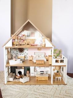 a doll house with furniture and accessories inside