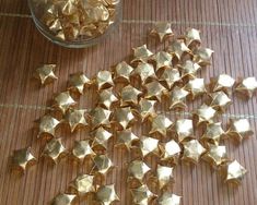 gold nuggets are scattered on the floor next to a glass bowl