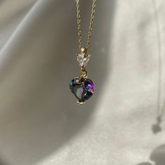 This necklace is an exquisite piece of jewelry that will add a touch of elegance to any outfit. The pendant is made of alexandrite, a unique gemstone that changes color depending on the lighting. The heart-shaped pendant is a beautiful multicolor that sparkles in the light. The pendant is set in a delicate gold chain that adds to the overall dainty look of the necklace. Alexandrite is the birthstone for June, making this necklace an ideal gift for anyone born in that month. It would also make a Elegant Heart Shaped Crystal Clavicle Necklace, Elegant Heart-shaped Crystal Necklace, Heart Shaped Jewel Necklace For Wedding, Heart-shaped Gemstone Necklaces For Weddings, Gemstone Heart Pendant Necklace For Wedding, Heart-shaped Gemstone Necklace For Wedding, Heart Shaped Gemstone Necklace For Wedding, Heart-shaped Gemstone Heart Necklace For Weddings, Elegant Crystal Necklaces For Valentine's Day Jewelry Making