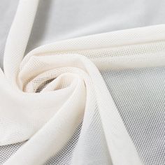 "Off White Stretch Power Mesh Fabric by the Yard Style 453 Off White Stretch Power Mesh Fabric by the yard, bulk, or wholesale. The mesh texture of this Off White Stretch power mesh allows moisture to escape, offering greater comfort than thicker stretchy fabrics such as spandex.This mesh creates a firm, yielding surface that you can cover with any fabric. Make those perfect lingerie, pillow stuffings holder and more with this fabric. This fabric is used for Lingerie, Clothing Supports, Home Dec White Mesh Fabric, Mesh Texture, Stretch Mesh Fabric, Sheer Drapes, Net Fabric, Hole Saw, Faux Fur Fabric, Fur Fabrics, Sports Wear