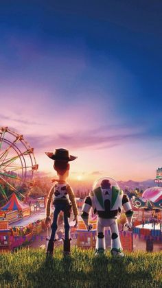 two toy story characters standing in front of an amusement park with ferris wheel and carnival rides