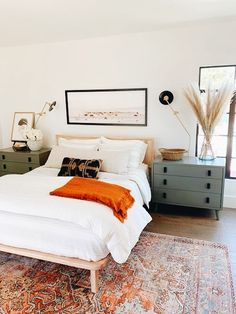 a white bed sitting in a bedroom on top of a rug