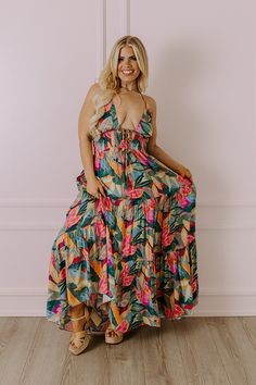 - Grab an umbrella drink and step into tropical style with this beautiful maxi! - Unlined lightweight material with a colorful abstract botanical print -A deep-v neckline featuring a tie detail with accent tassels - Halter tie closure with accent tassels - An open back - A smocked lower bodice - Hidden side pockets - A flowy yet flattering silhouette that ends in a straight ankle length hemline Tropical V-neck Maxi Dress With Vibrant Print, Vibrant Green Tropical Print Maxi Dress, Green Maxi Dress With Vibrant Print For Brunch, Tropical Maxi Dress With Vibrant Print For Garden Party, Green Tropical Dress With Vibrant Print, Tropical Green Dress With Vibrant Print, Vibrant Green Floral Print Maxi Dress, Green Tropical Print Maxi Dress For Garden Party, Multicolor Maxi Dress With Tropical Print