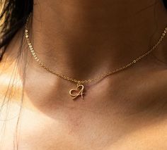 Elevate your style with our Personalized Heart-Shaped Initial Letter Necklace, a stunning 18k gold-plated accessory designed for teens and girls. This heart necklace isn't just a piece of jewelry; it's a symbol of individuality.  Personalize it with the letter that means the most to you, creating a unique and meaningful keepsake. Crafted with precision, this necklace is a perfect blend of elegance and personal touch. Embrace the beauty of self-expression with our Heart Necklace - a cherished gift for any occasion HOW TO ORDER: -->Write your preferred letter in the personalization box --> Complete the purchase VARIATIONS: Color options: 18K Gold Plating Length: 45cm PRODUCT FEATURES: ✨ Handcrafted Brilliance: Each of our Initial Name Letter Necklaces is painstakingly crafted by hand, showca Initial Letter Necklace, Necklace For Women Gold, Gold Letter Necklace, Stainless Steel Chain Necklace, Heart Shaped Necklace, Handmade Heart, Birthday Jewelry Gift, Letter Pendants, Initial Letter