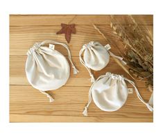 two white draws bags sitting on top of a wooden table