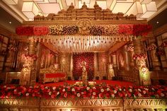 a decorated stage with red and gold flowers