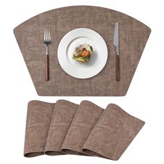 placemats, napkins and forks are laid out on the table for dinner