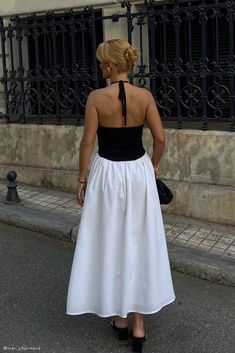 It's black and white.The KATIE is a duo-hue dress, styled into a midi length and crafted from a knit and linen fabrication. We designed it to showcase your shoulders with a halter neckline and crafted it to be fully lined along the skirt for comfortable non-see through day wear. White Summer Halter Top For Evening, White Halter Top For Summer Evening, White Halter Top For Summer Evening Events, Black And White Sleeveless Midi Dress For Summer, Black And White Midi Dress For Summer Evenings, White Midi Halter Dress For Day Out, White Midi Length Halter Dress For Day Out, Chic Black And White Midi Dress For Summer, Chic Summer Black And White Midi Dress