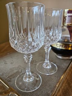 two wine glasses sitting on top of a tray