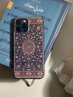 an iphone case sitting on top of a book