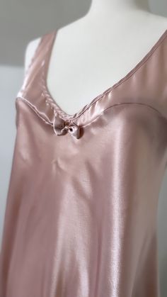 Indulge in the epitome of timeless romance with this authentic Vintage Satin-Style Babydoll Nightgown in mint condition. A luxurious, sweet, and romantic piece.  🎀 Key Features: Feminine Bow Detail: Adorned with a delicate bow feature on the front, this nightgown adds a touch of elegance and femininity to your bedtime routine. Sweetheart Seams: The sweetheart seams delicately accentuate the neckline, creating a flattering silhouette that enhances your natural curves. Muted Pale Pink: The soft, Elegant Silk Slip Dress For Bedtime, Feminine Camisole Nightgown For Wedding, Feminine Bias Cut Nightgown For Wedding Night, Vintage Satin Sleepwear For Wedding, Vintage Satin Wedding Sleepwear, Elegant Pink Slip Dress For Bedtime, Vintage Satin Nightgown For Sleep, Vintage Satin Sleepwear, Vintage Camisole Sleepwear For Bedtime