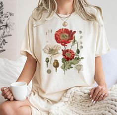 Botanical Shirt,Botanica Tee, Wildflower Shirt, Garden Shirt, Plant Lover Gift,Wildflower Tee,Plant Shirt,Boho Wildflowers,Cottagecore Shirt ⭐Please Check All Photos For Details.   🐞Choose Your T-Shirt Size From The Drop-Down Lists Next To The item Picture   ⭐Choose Of Your T-Shirt Color From The 2nd Picture   🐞Use "Add message to Seller" link On The Checkout Page To Send me the Following important Details For Your Order's Customization.   ⭐Shipping Time Varies by location (we are located in S Vintage White Tops With Plant Print, Cottagecore Tops With Plants Print And Relaxed Fit, Cottagecore Tops With Plant Print And Relaxed Fit, Cottagecore Relaxed Fit Tops With Plant Print, Relaxed Fit Cottagecore Tops With Plant Print, Cottagecore Floral Print Summer Shirt, White Floral Print Hippie Top, Cottagecore Printed Relaxed Fit Top, Cottagecore Printed Tops With Relaxed Fit