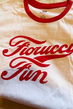 🖤 Have fun making a statement in this playful and eco-friendly Fiorucci Brand t-shirt. The white color with red trim perfectly complements the bold "Fiorucci Fun" logo. Made of 100% cotton, this shirt is comfortable, breathable, and versatile for both men and women. (Available for him and her!) 🖤 Item Features: Fiorucci Fun; White, red trim, red printed letter logo detail, round neckline, short sleeve, relaxed fit, unlined, stretchy, not see through, casual, comfy, breathable, eco, 100% cotton Friendly Branding, Fun Logo, Men Mode, Cool Logo, Letter Logo, Print Logo, Wholesale Clothing, Logo T Shirt, Branded T Shirts