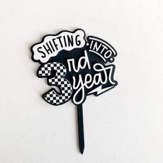 a black and white sticker that says shifting into the year on it's side