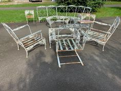 a group of metal furniture sitting on top of a parking lot