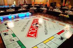 a monopoly board game set up in a banquet hall