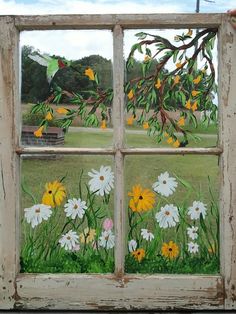 an old window with flowers painted on the glass and birds flying in the sky above