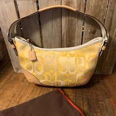 Nwot Coach Vintage Purse. Brand New Without Tags, Never Used. Iconic Coach Logo In Beautiful Shades Of Yellow With Leather Bottom. Big Side Adjustable Buckles. Opening Is Approximately 11 Inches. Bought A Few Years Ago And Never Used It, My Loss Is Your Gain. Comes With Dustbag. Thank You For Stopping By My Closet All Reasonable Offers Will Be Considered. Yellow Coach Bag, Yellow Vintage Bags, Classic Yellow Coach Bag, Classic Yellow Shoulder Bag With Handles, Retro Yellow Shoulder Bag For Shopping, Yellow Retro Shoulder Bag For Shopping, Yellow Vintage Shoulder Bag For Shopping, Classic Yellow Shoulder Bag, Yellow Coach Shoulder Bag With Gold-tone Hardware