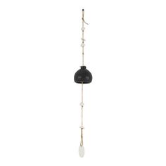 a black and white lamp hanging from a metal pole with beads on the end, in front of a white background