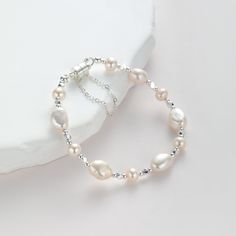 ITEM DETAILS -Bracelet Length: Small (17.5cm),  Medium (18.5cm),  Large(19.5cm) -Bead size: Freshwater pearl :8mm/5mm/2.5mm, Silver Beaded: 2mm -Clasp: Magnetic buckle with safety chain -Material: 14k Gold plated, sterling sliver plated  -Color: Gold, Silver Please click the link for matching necklace and earrings: https://karabeardesign.etsy.com/listing/1769348005/classic-natural-freshwater-pearl --------------------------------- -CRAFTSMANSHIP: My jewelry is handmade in New Jersey Studio. I fo Pearl Wedding Jewelry, Pearl Beaded Bracelet, Pearl Jewelry Wedding, Bracelet Dainty, Jewelry Pearl, Freshwater Pearl Bracelet, Wedding Jewelry Bracelets, Natural Pearl, Pearl Wedding