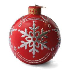 a red ornament with white snowflakes on it