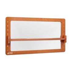 a large mirror mounted to the side of a wooden frame with studs on it