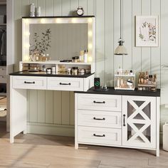 a white vanity with lights on it in a room