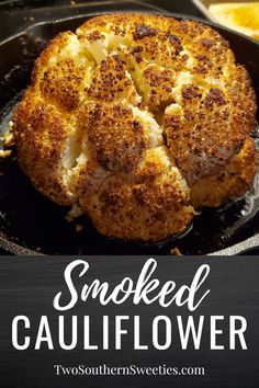 a skillet with cauliflower in it and the words smoked cauliflower