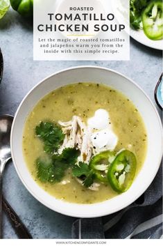 a white bowl filled with chicken soup and topped with sour cream, cilantro, jalapenos