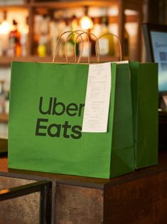 a green shopping bag sitting on top of a counter