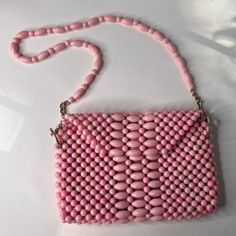 1960s 1970s pink bead purse. Beads are plastic. Small size 9 1/2" wide x 6" tall x 1" Chain / handle. Total amount is 30" with 10" drop. The lining is spotted all over Otherwise bag is in good condition. You could make a new lining and stitch to old lining pretty easy. tag says Hong Kong weighs 1 lb 2 ozs Cheap Beaded Pink Shoulder Bag, Cheap Pink Beaded Shoulder Bag, Bead Purse, Pink Beaded, Beaded Handbag, Beaded Purses, Pink Beads, Purses And Handbags, Hong Kong