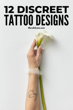 a woman's arm holding a flower with the words 12 discreet tattoo designs on it