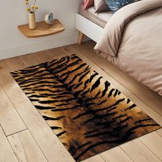 a tiger print rug on the floor in a bedroom