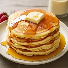 a stack of pancakes with butter and syrup