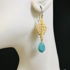 A decorative handicraft art began from the most prosperous Tang Dynasty in China, Chinese Knot is actually inspired by how Chinese inherited the civilization from the divine: They use knots as a record of their life and history when character were not developed in very ancient times. ⚜Item Specifics❀ Gold Plated Chinese Knot and Ear Wire❀ Turquoise Howlite Teardrop❀ Earring Length Measures 3.5 inch Turquoise Brass Spiritual Jewelry, Elegant Artistic Drop Earrings Jewelry, Traditional Artistic Design Drop Earrings, Artisan Turquoise Brass Jewelry, Elegant Turquoise Brass Jewelry, Adjustable Drop Earrings With Artistic Design, Traditional Turquoise Jewelry With Intricate Design, Turquoise Traditional Jewelry With Intricate Design, Traditional Dangle Jewelry With Artistic Design