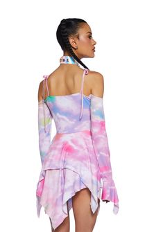 cuz you make this world magical. This mini dress has an all over rainbow tie dye print, comes with off the shoulder sleeves, spaghetti straps with tie closures, ruching at the chest with a tie closure, and a handkerchief detail, hem, and cuffs.