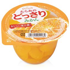 an orange is in a plastic container with some writing on the label and it's inside