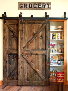 an open barn door with the word grocery on it in front of a pantry filled with food