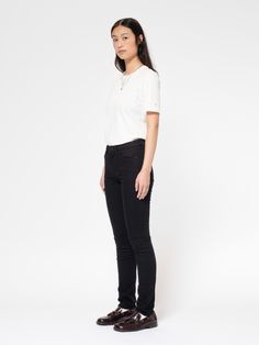 A mid-waist, slim-fit with a straight leg in organic denim that stays black. Our Everblack fabric is made to maintain its color for as long as possible, withstanding 40, or more washes without any significant loss of color. To optimize the denim for the fit, these jeans have been rinsed, making the jeans stretchy and soft. If you are looking for a pair of pitch-black jeans that do not fade this is the way to go.    Keen on knowing what differentiates Everblack from other black denim?   Normally, when denim is dyed part of the dye will absorb in the cotton fibers while the rest remains bound only to the surface of the yarns. This is what gives denim its aging property that in many cases is sought after. However, when it comes to black jeans this is not always the case which is why we develo Casual Black Straight Silhouette Bottoms, Casual Black Bottoms With Straight Silhouette, Neue Outfits, Nudie Jeans, Way To Go, Shirts & Tops, Fit Jeans, Black Denim, Cotton Fiber