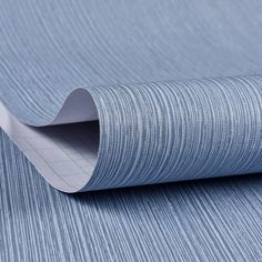 a close up view of a blue wallpaper with vertical lines on the bottom half