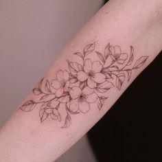 a woman's arm with flowers on it