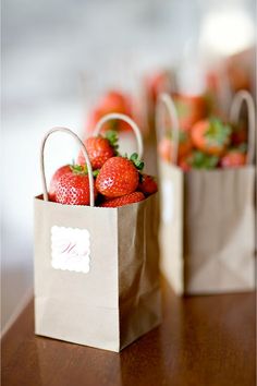 some strawberries are in a paper bag on a table