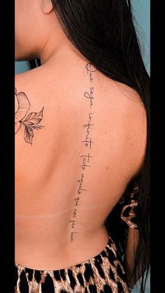 the back of a woman's neck with writing on her lower back and upper arm